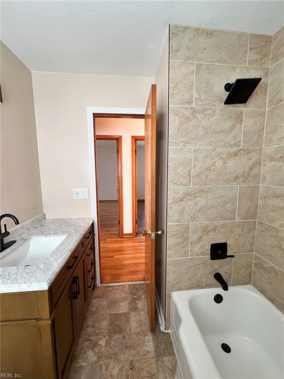 full bath featuring vanity and washtub / shower combination