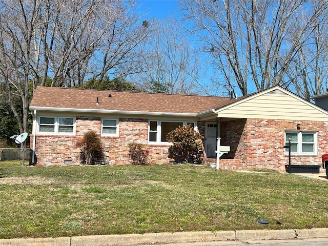 ranch-style home featuring brick siding, crawl space, a shingled roof, and a front yard