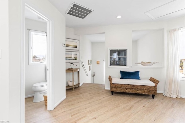 living area featuring recessed lighting, light wood-style floors, visible vents, and baseboards