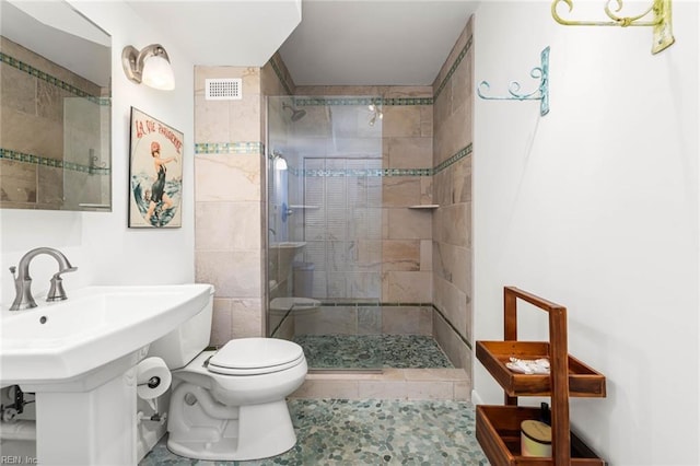 full bathroom with visible vents, toilet, and a shower stall