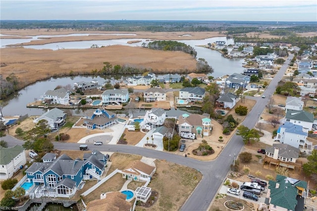 bird's eye view featuring a water view and a residential view