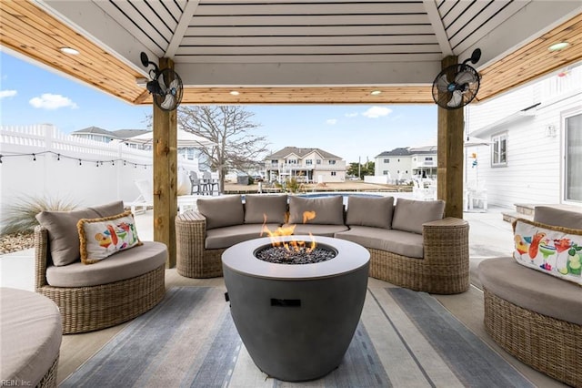 view of patio / terrace with a residential view, an outdoor living space with a fire pit, and fence