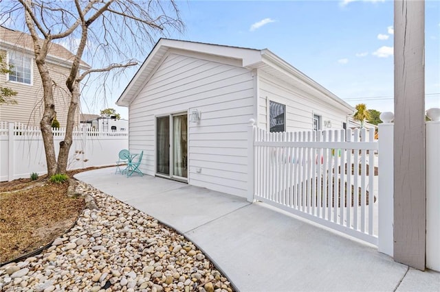 rear view of house with a patio, fence private yard, and a gate