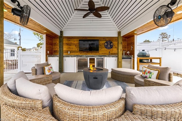 view of patio / terrace with beverage cooler, fence, a gazebo, outdoor lounge area, and ceiling fan