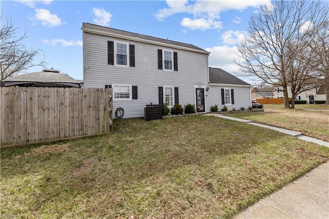 view of front of house with a front yard and fence