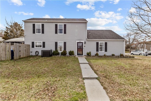 view of front facade with a front lawn and fence