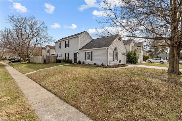 view of side of property with fence, a lawn, and a residential view