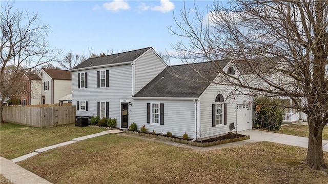 view of front facade with fence, concrete driveway, an attached garage, a shingled roof, and a front yard