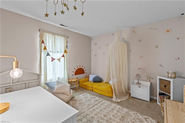 carpeted bedroom featuring visible vents and a textured ceiling