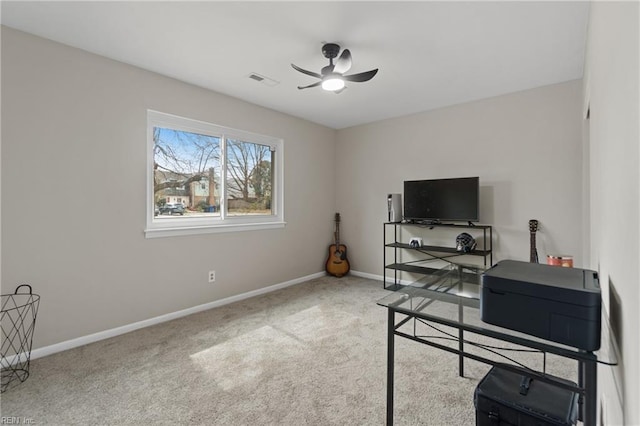 carpeted office with visible vents, a ceiling fan, and baseboards