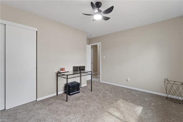 office space featuring baseboards, a ceiling fan, and carpet flooring