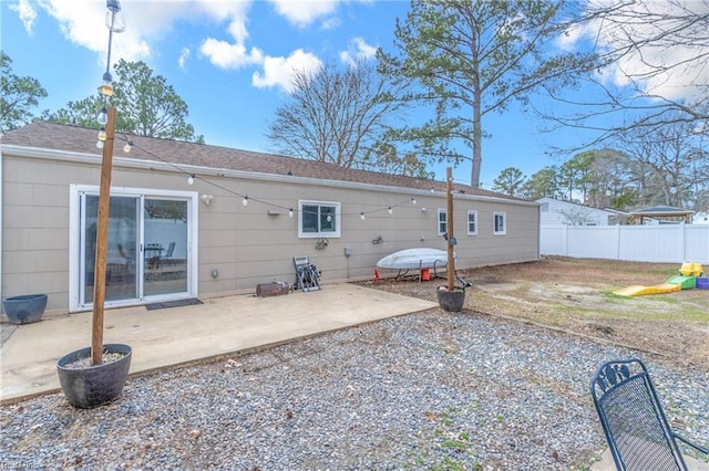 rear view of house featuring a patio and fence