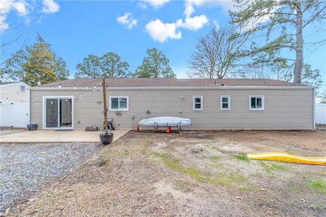 rear view of property featuring a patio area and fence