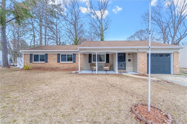 single story home featuring concrete driveway, a porch, brick siding, and a garage