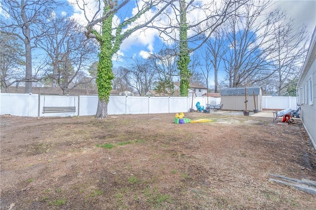 view of yard with an outbuilding, a storage shed, and a fenced backyard