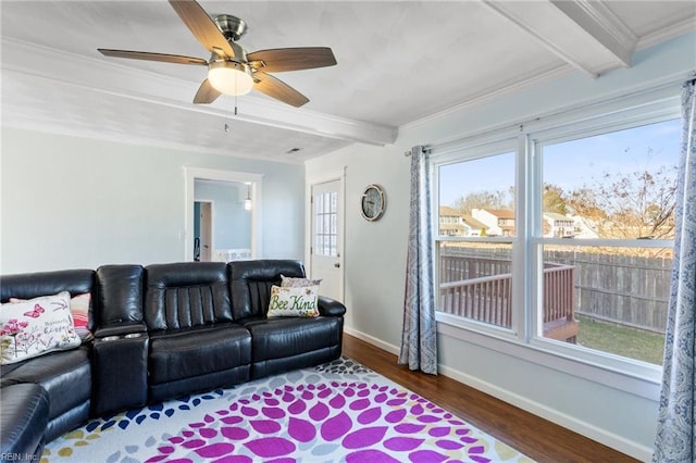 living room with crown molding, ceiling fan, baseboards, beam ceiling, and wood finished floors