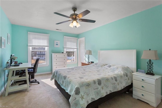 bedroom featuring a ceiling fan, baseboards, visible vents, and light carpet