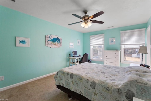 bedroom with a ceiling fan, visible vents, baseboards, and carpet floors