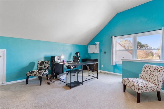 carpeted office space featuring lofted ceiling and baseboards