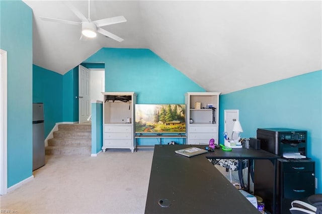 carpeted office space featuring ceiling fan and vaulted ceiling