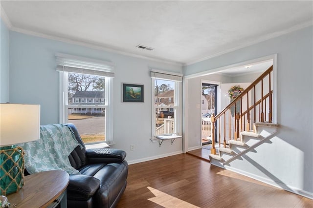 sitting room with visible vents, crown molding, baseboards, stairway, and wood finished floors