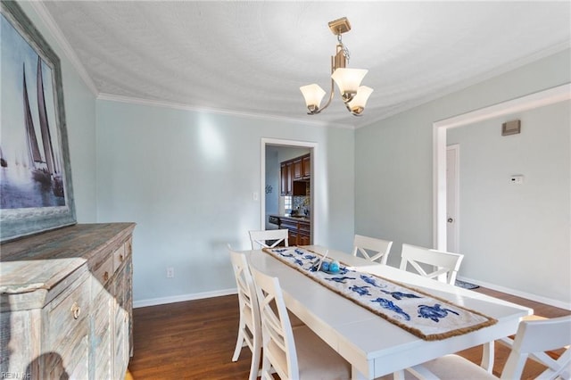 dining room featuring crown molding, baseboards, dark wood-style flooring, and a chandelier