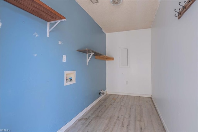 clothes washing area with baseboards, electric panel, laundry area, hookup for a washing machine, and wood finished floors