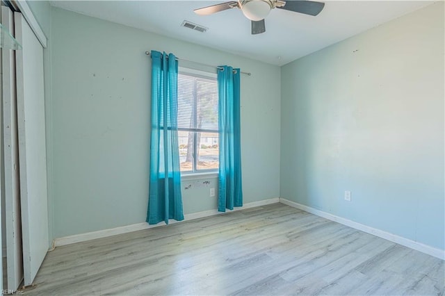 unfurnished bedroom with visible vents, wood finished floors, a closet, baseboards, and ceiling fan