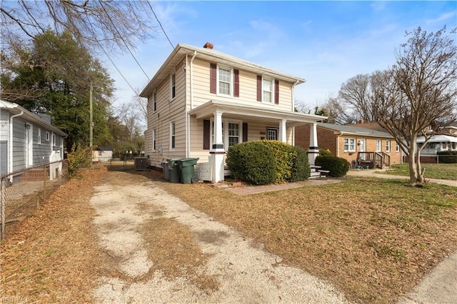 view of front of house featuring fence, a porch, a front yard, central AC, and driveway