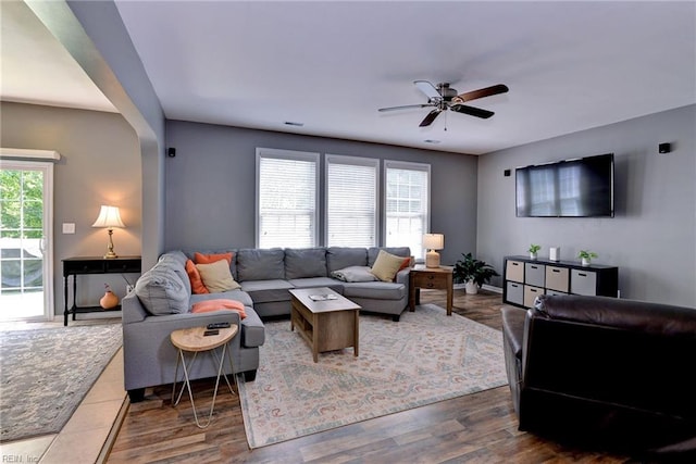 living area with wood finished floors and a ceiling fan