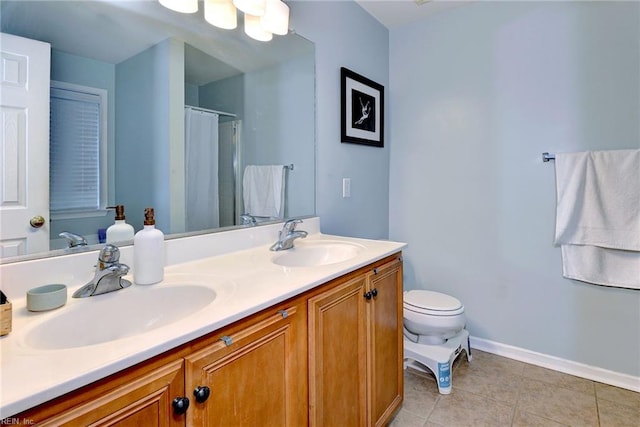 bathroom with tile patterned flooring, double vanity, toilet, and a sink