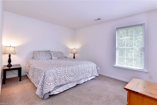 bedroom featuring visible vents, multiple windows, baseboards, and carpet floors