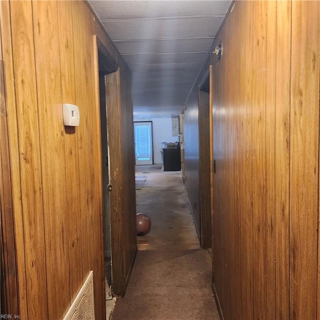 hallway with wooden walls and visible vents