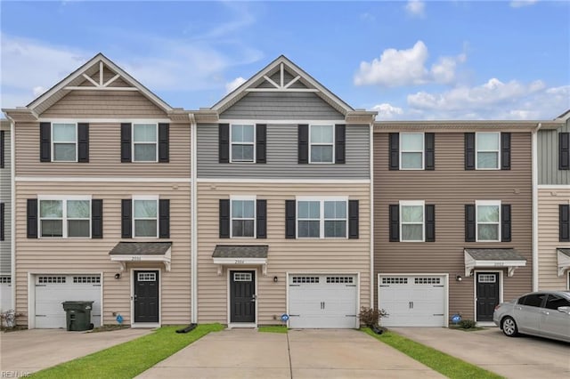 multi unit property featuring driveway and an attached garage