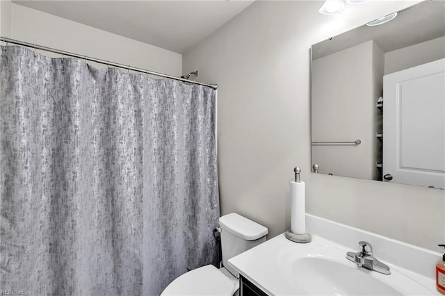 bathroom with vanity, toilet, and a shower with curtain