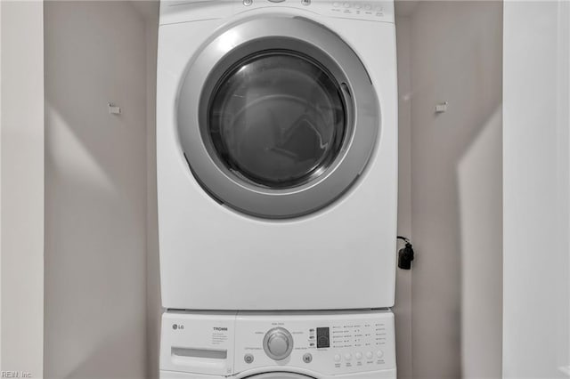 washroom featuring laundry area and stacked washer and clothes dryer