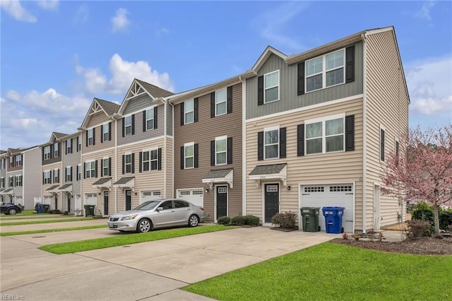 townhome / multi-family property with a residential view, a front lawn, concrete driveway, and a garage