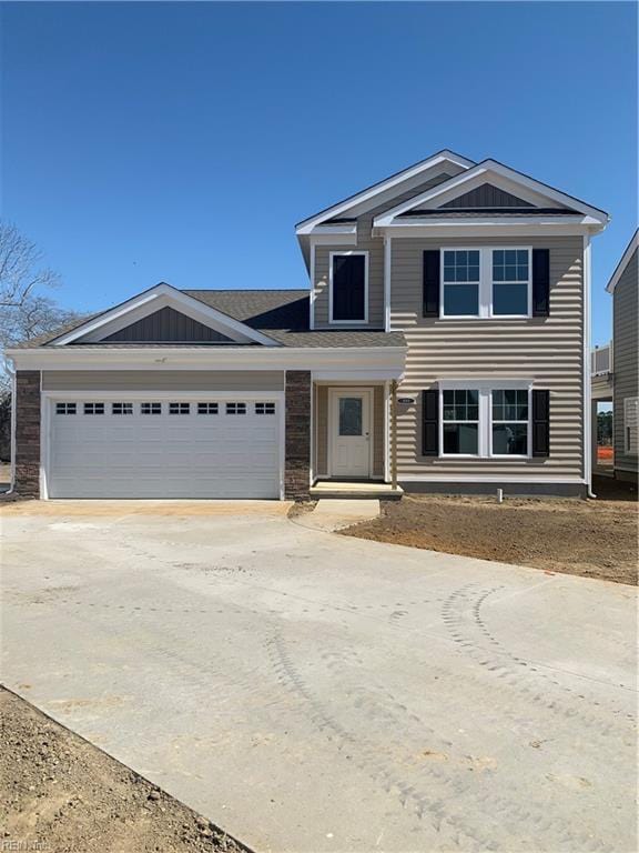 view of front of home featuring concrete driveway and an attached garage