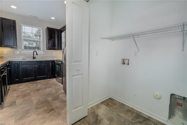 laundry room with washer hookup, a sink, recessed lighting, baseboards, and laundry area