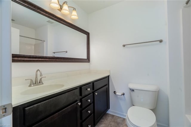 bathroom featuring a shower, baseboards, toilet, and vanity