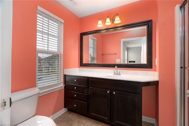 bathroom with tile patterned flooring, visible vents, baseboards, toilet, and vanity