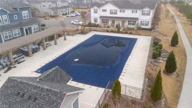 exterior space featuring fence, a patio area, and a residential view