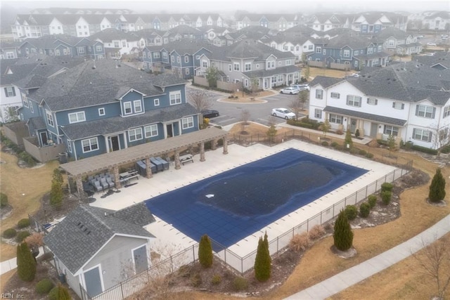 view of swimming pool featuring a residential view, a patio, and a fenced backyard