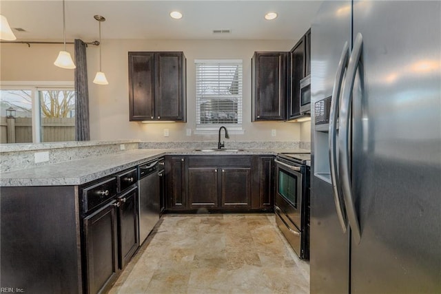 kitchen featuring a sink, a wealth of natural light, appliances with stainless steel finishes, and a peninsula