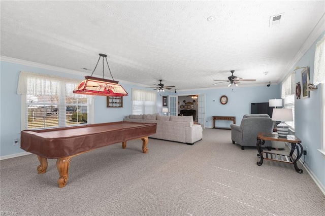 game room with visible vents, baseboards, light colored carpet, ornamental molding, and a textured ceiling