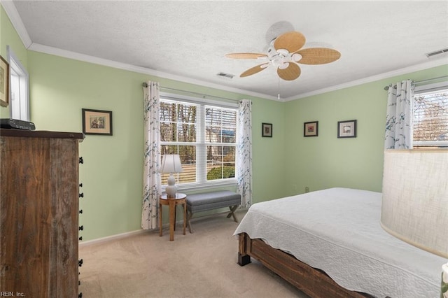 carpeted bedroom featuring crown molding, baseboards, visible vents, and a textured ceiling