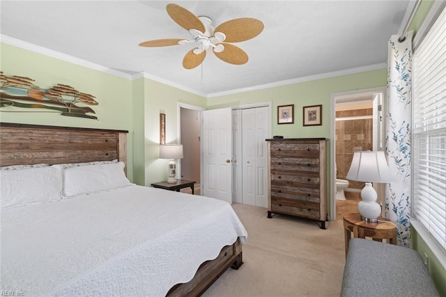 bedroom featuring ceiling fan, ornamental molding, light carpet, ensuite bathroom, and a closet