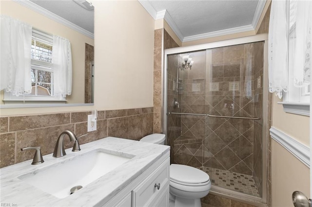 bathroom featuring crown molding, toilet, a stall shower, and a textured ceiling