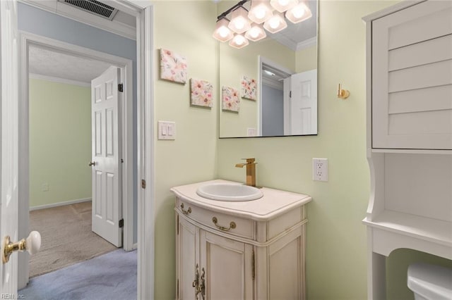 bathroom with vanity, baseboards, visible vents, and ornamental molding