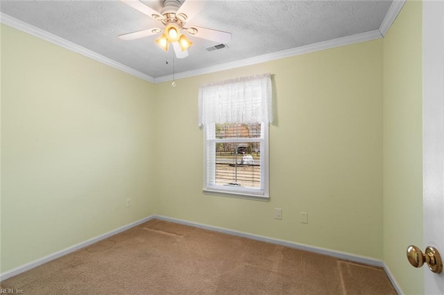 carpeted spare room featuring visible vents, ornamental molding, a ceiling fan, a textured ceiling, and baseboards